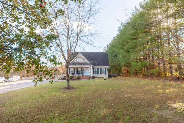 cape cod home with a front yard