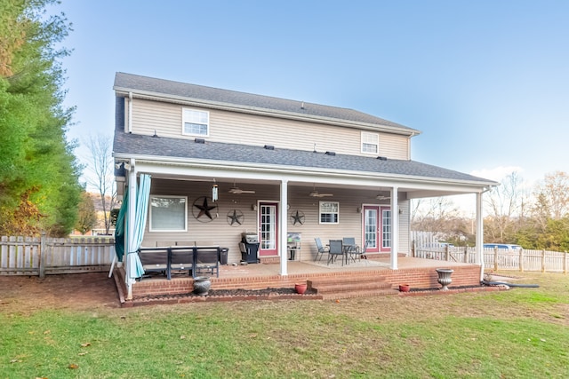 back of house with a lawn, ceiling fan, a patio area, and french doors