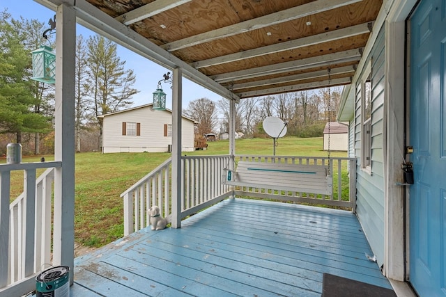 wooden terrace featuring a lawn