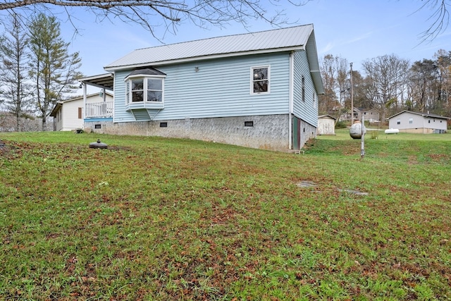 back of property with a yard and a shed