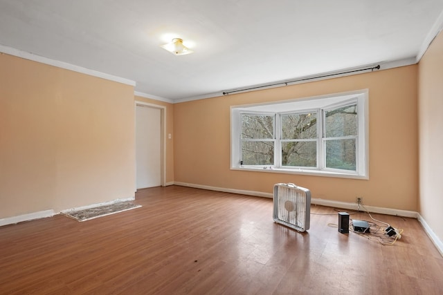 unfurnished room with wood-type flooring and ornamental molding