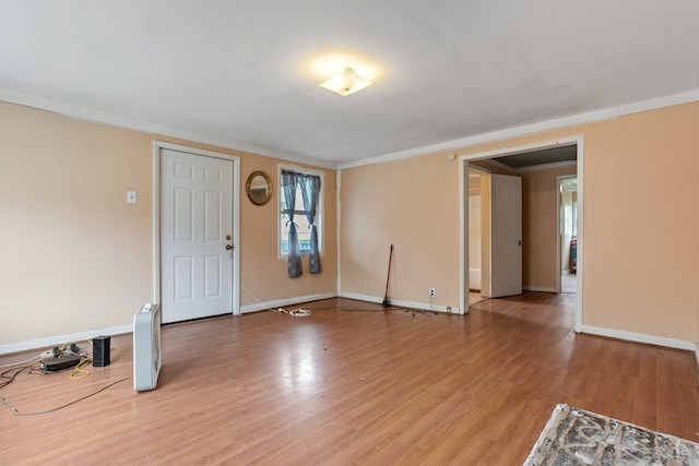 interior space featuring light wood-type flooring and ornamental molding