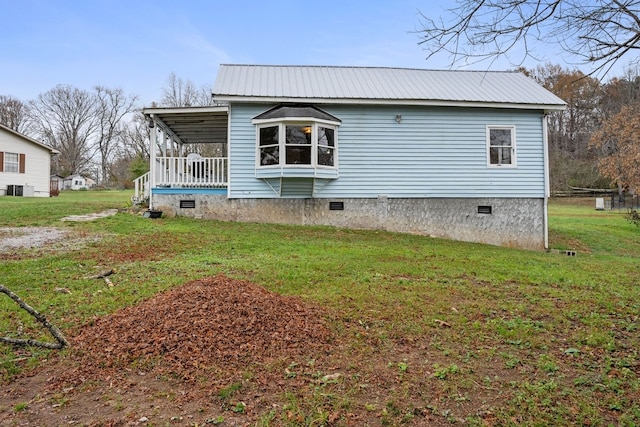 view of home's exterior with a lawn and covered porch