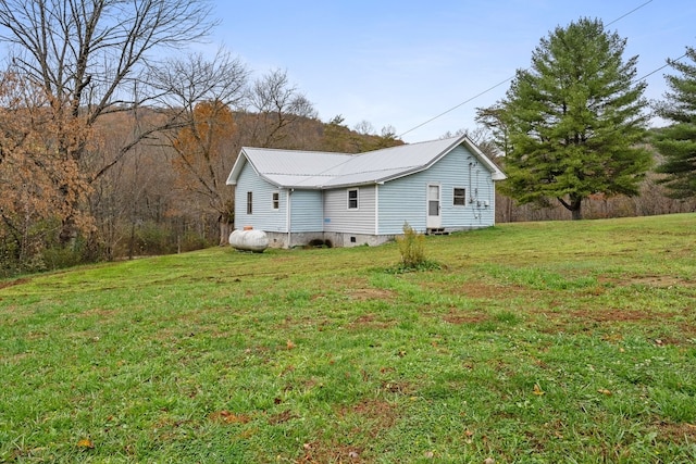 view of side of home featuring a yard