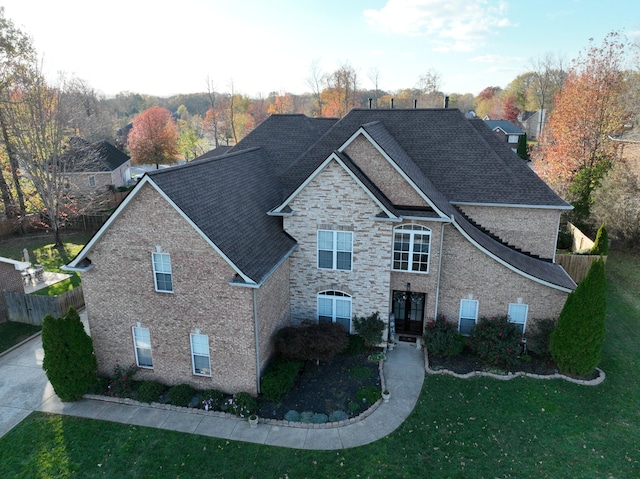 view of front of house with french doors and a front lawn