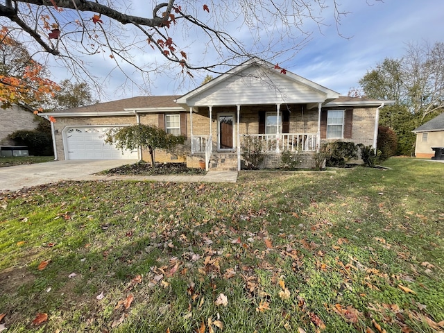 single story home with covered porch, a garage, and a front lawn