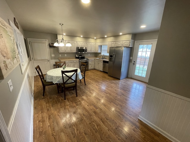 dining space with dark hardwood / wood-style flooring and sink