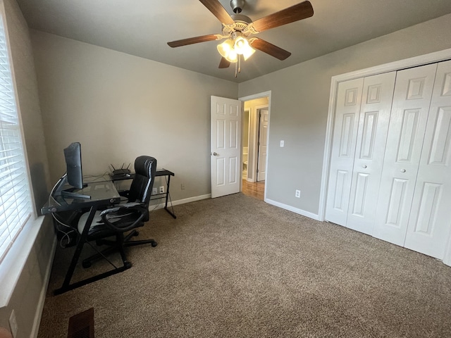 carpeted office featuring ceiling fan