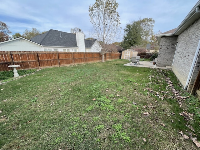 view of yard featuring a patio area and a shed