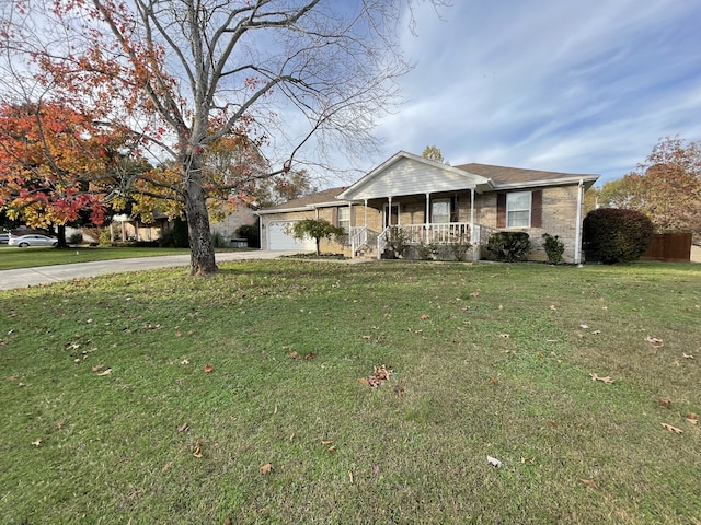 single story home featuring covered porch, a garage, and a front lawn