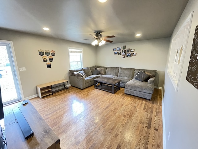 living room featuring ceiling fan and light wood-type flooring