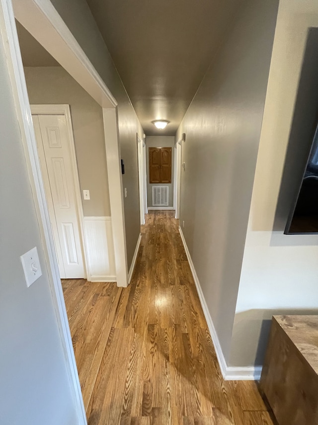 corridor featuring wood-type flooring