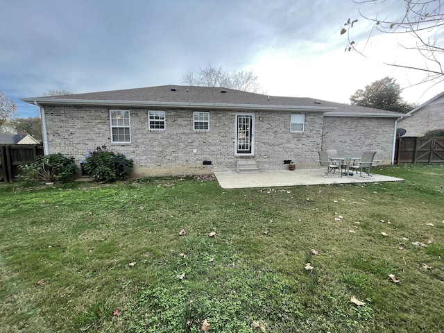 rear view of house featuring a yard and a patio