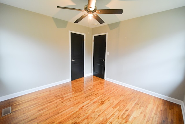 empty room featuring ceiling fan and light hardwood / wood-style floors