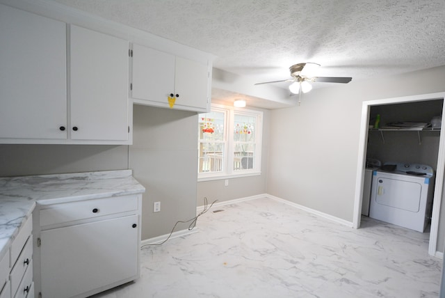 laundry area with washer / dryer, a textured ceiling, and ceiling fan