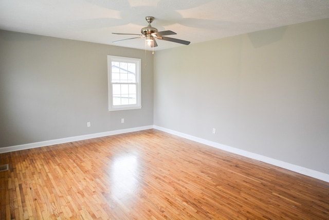 spare room featuring a textured ceiling, light hardwood / wood-style floors, and ceiling fan