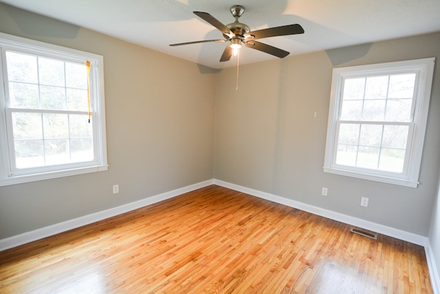 spare room featuring light hardwood / wood-style flooring and ceiling fan