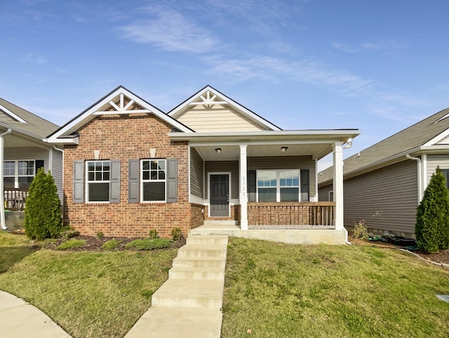 view of front of property with a front yard and a porch