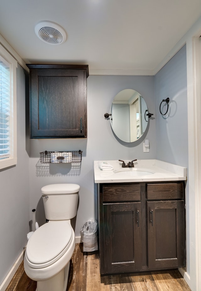 bathroom featuring hardwood / wood-style floors, vanity, and toilet