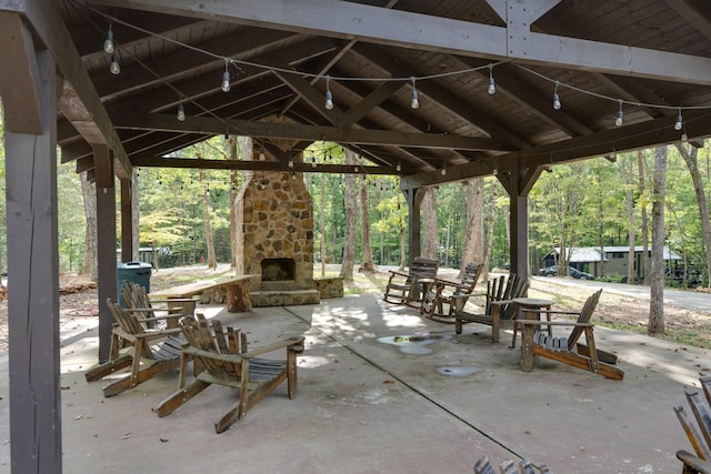 view of patio / terrace with a gazebo and an outdoor stone fireplace