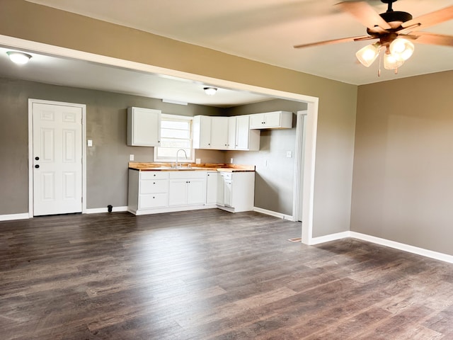 kitchen with butcher block counters, ceiling fan, sink, dark hardwood / wood-style floors, and white cabinets