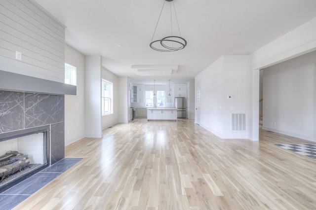 unfurnished living room with light hardwood / wood-style floors