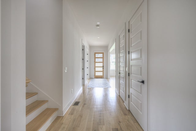 corridor with light hardwood / wood-style flooring