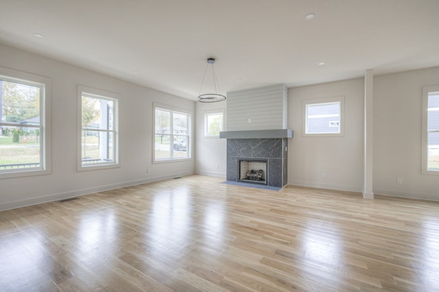 unfurnished living room with light hardwood / wood-style floors and a fireplace