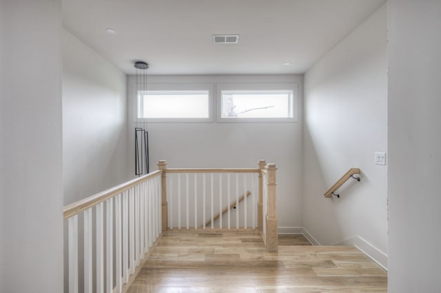 stairs with hardwood / wood-style flooring