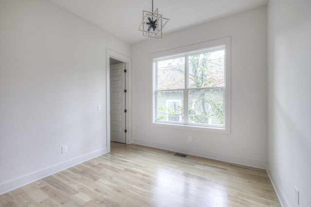 spare room with light wood-type flooring