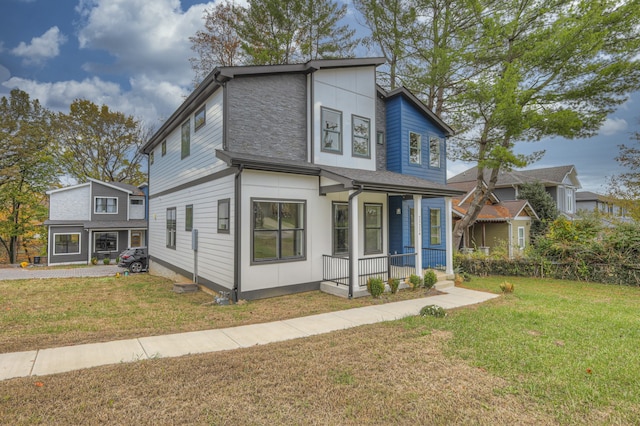 view of front of house with covered porch and a front yard