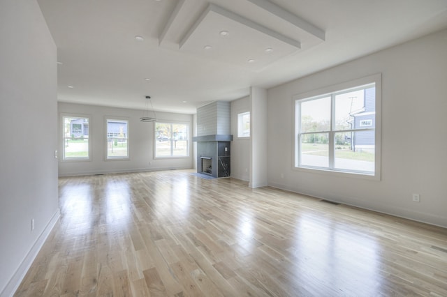 unfurnished living room with light wood-type flooring