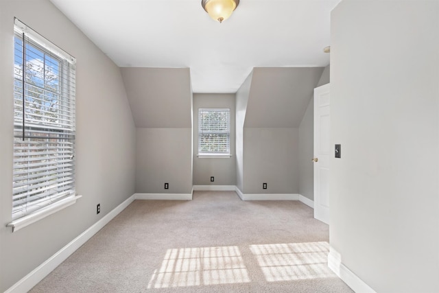 bonus room featuring light carpet, vaulted ceiling, and a wealth of natural light