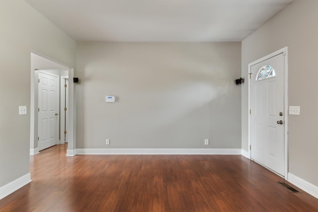 foyer with dark hardwood / wood-style floors