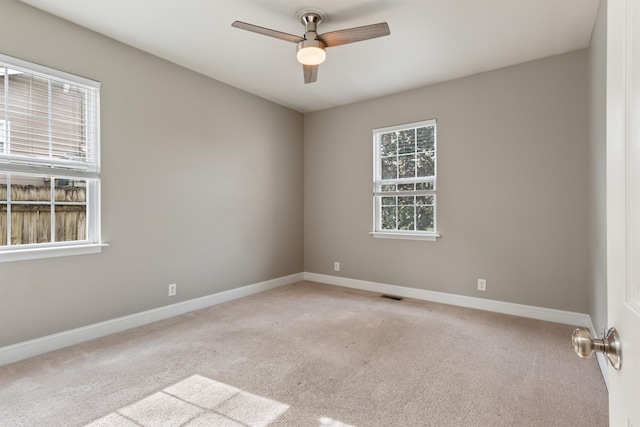 unfurnished room featuring light carpet and ceiling fan