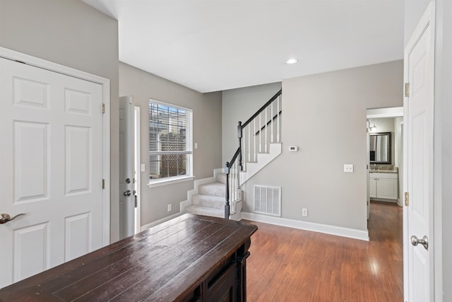 entryway with dark wood-type flooring