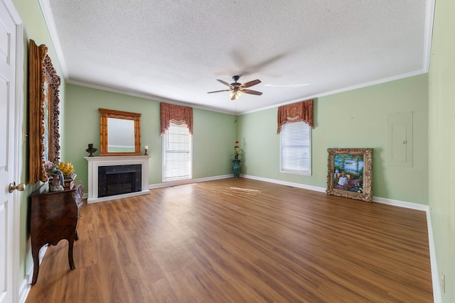 living room featuring a textured ceiling, dark hardwood / wood-style floors, plenty of natural light, and crown molding