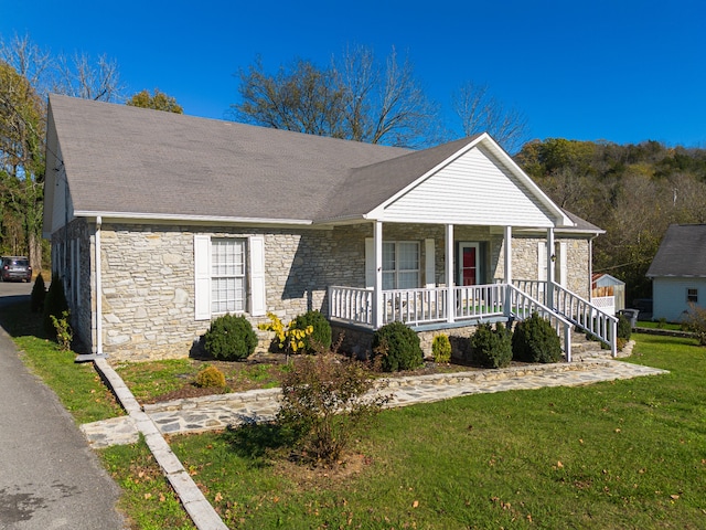 view of front facade with a porch and a front lawn