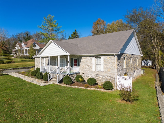 ranch-style house featuring a porch and a front lawn