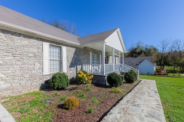 view of property exterior featuring a lawn and covered porch