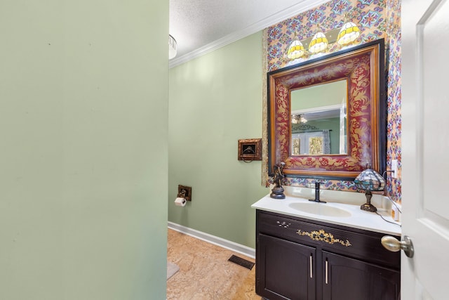 bathroom featuring vanity, a textured ceiling, and ornamental molding