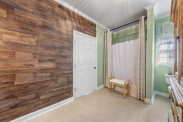 bathroom with wooden walls, toilet, tile patterned flooring, and ornamental molding