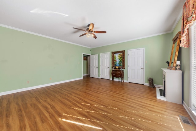 unfurnished bedroom with ceiling fan, light hardwood / wood-style floors, and crown molding