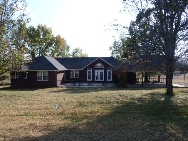 ranch-style home with a front lawn