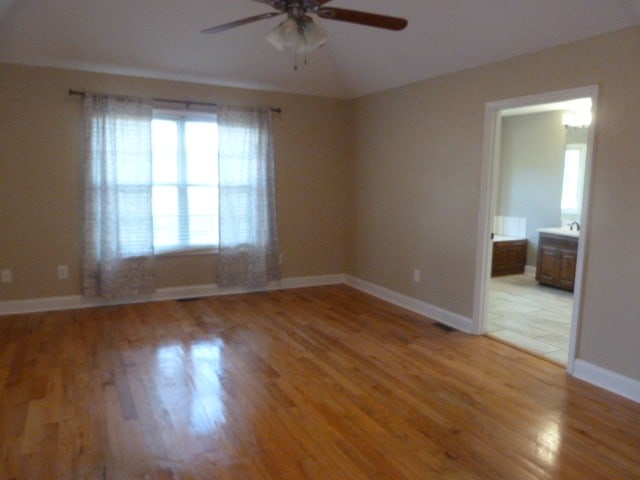 unfurnished room with ceiling fan and hardwood / wood-style flooring