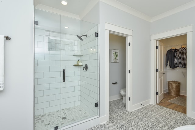 bathroom with toilet, an enclosed shower, tile patterned floors, and crown molding