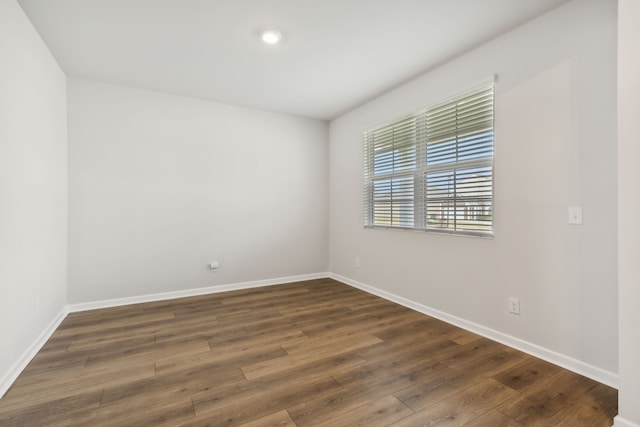 spare room featuring dark hardwood / wood-style flooring