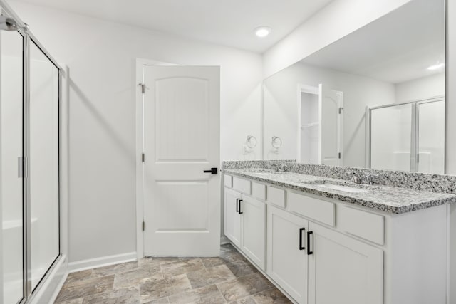 bathroom featuring vanity and an enclosed shower