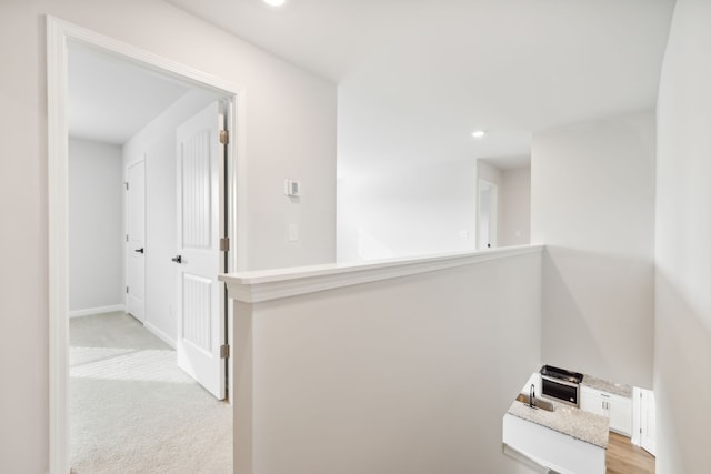 corridor with light colored carpet