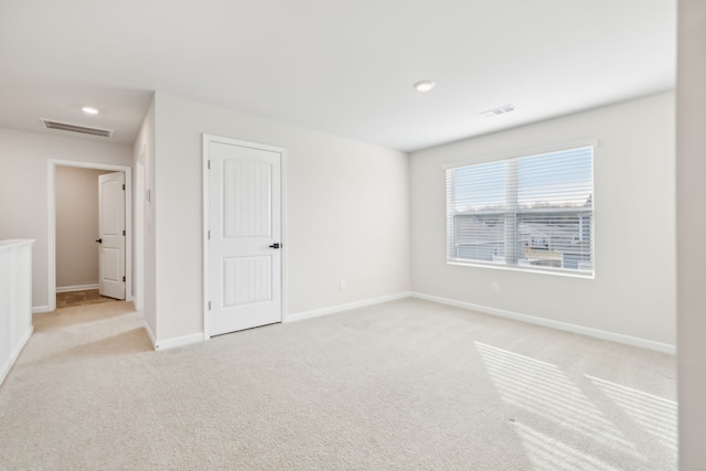 spare room with light colored carpet